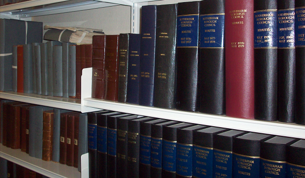 Archived documents on storage shelves. 