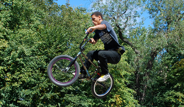 Youth on a BMX bike flying through the air