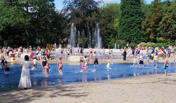 Children playing and having fun in the water splash attraction.